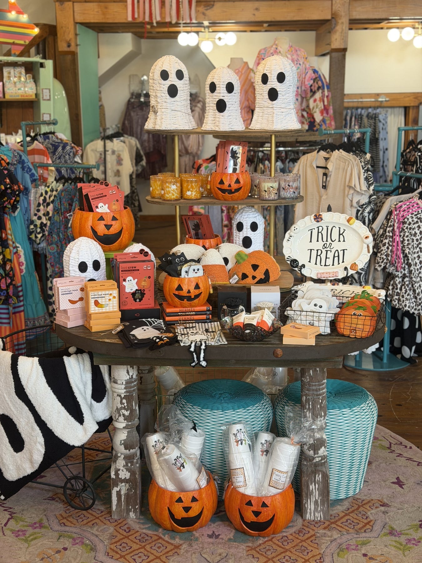 table full of halloween items. pillows, candles, face masks, cups