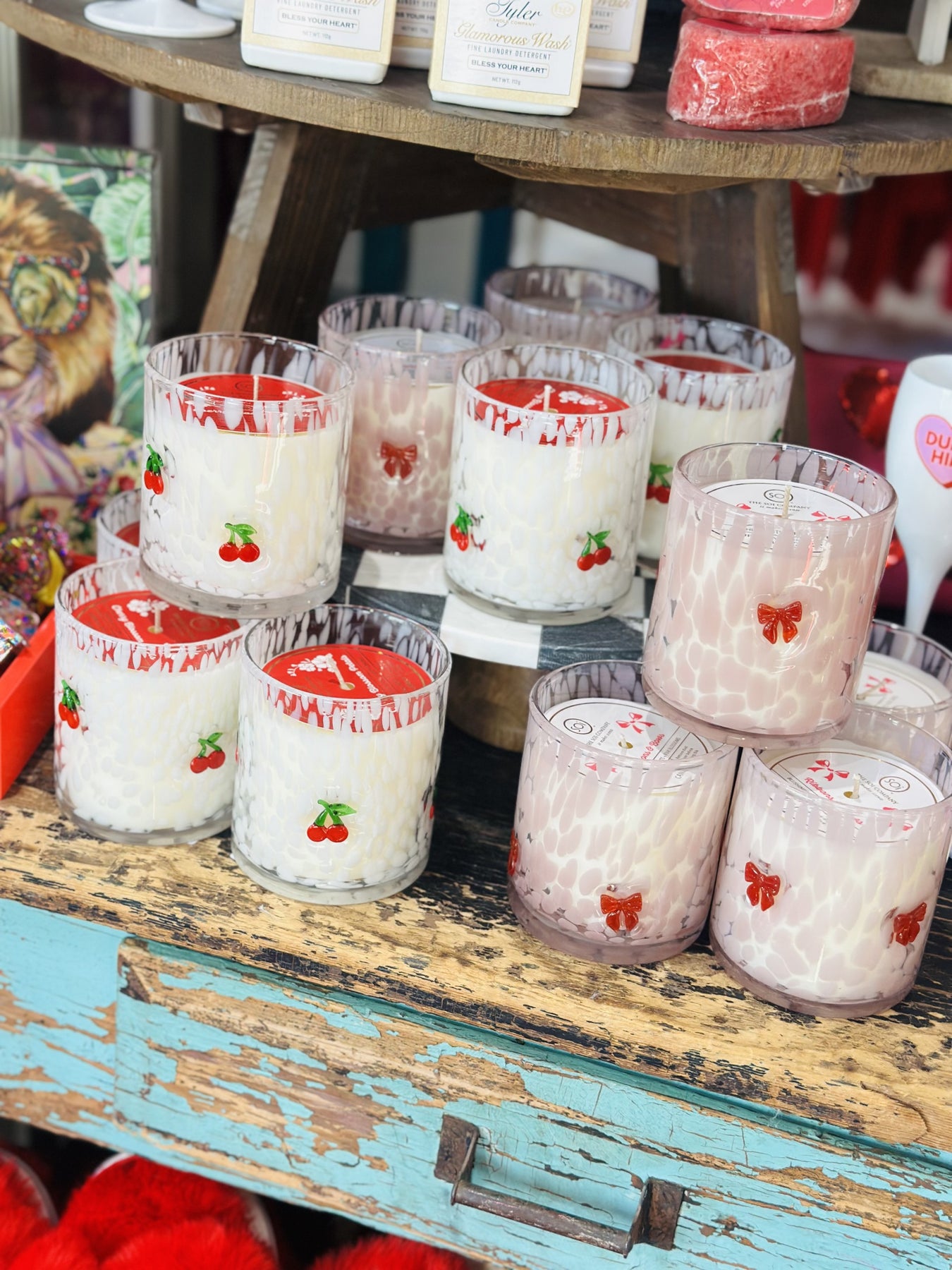candles  with cherries and bows on jar